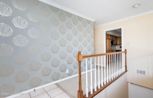 hallway featuring crown molding and light tile patterned flooring