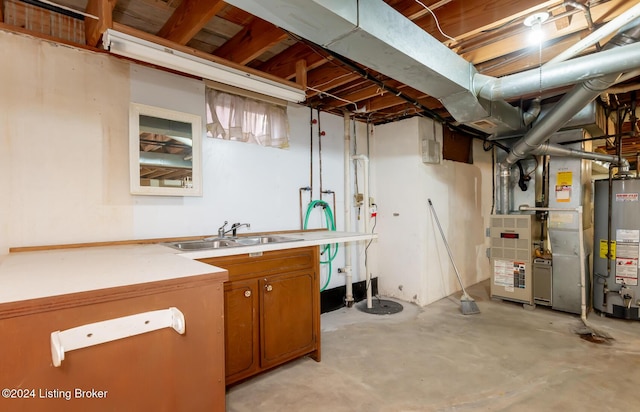 basement featuring heating unit, sink, and water heater