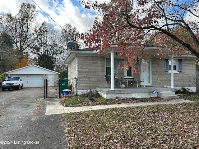 view of front of house with an outbuilding, a porch, and a garage