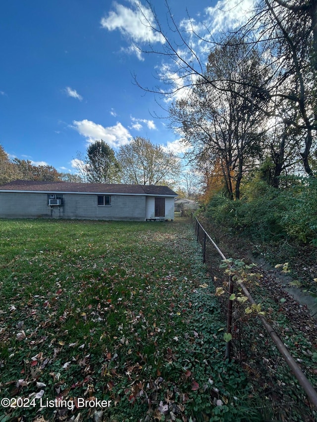 rear view of house featuring a yard