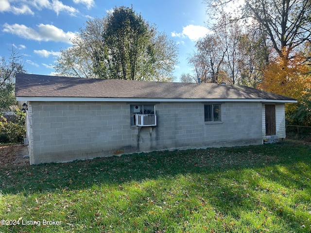 view of home's exterior featuring cooling unit and a lawn