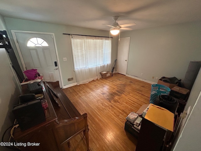 foyer entrance featuring wood-type flooring and ceiling fan