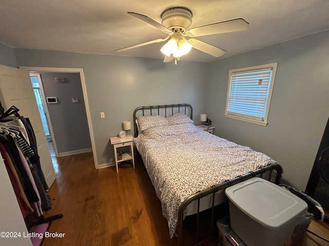 bedroom with ceiling fan and dark wood-type flooring