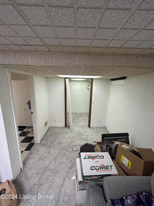 basement featuring carpet and a drop ceiling