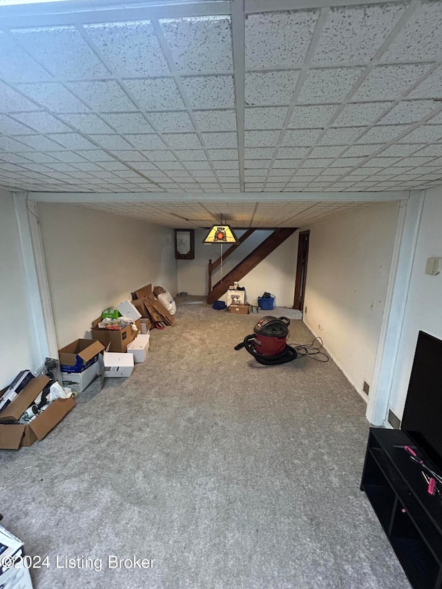 interior space featuring carpet floors and a drop ceiling