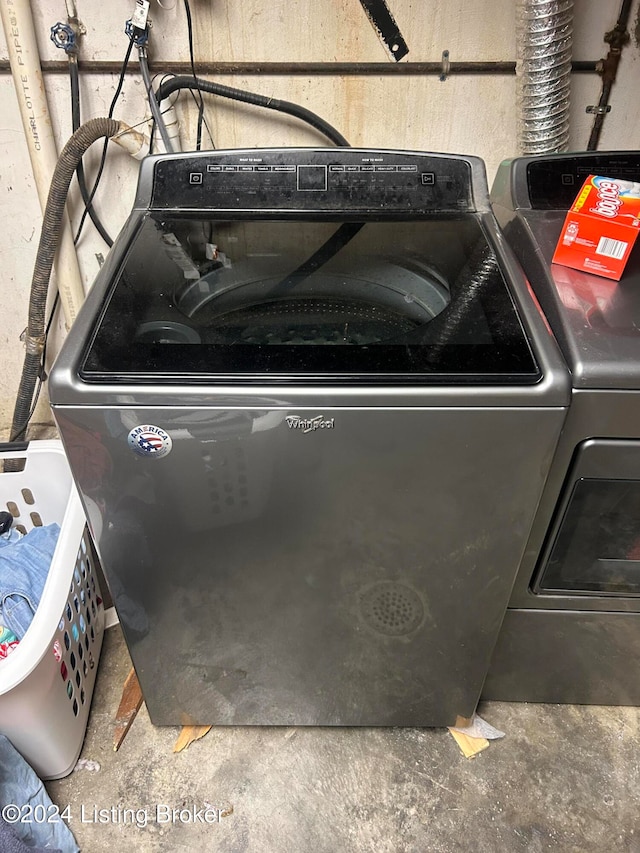 interior space featuring separate washer and dryer and concrete floors