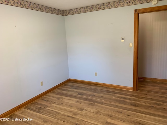 unfurnished room with hardwood / wood-style flooring