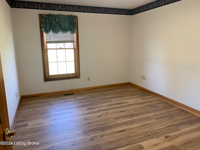 unfurnished room featuring hardwood / wood-style flooring