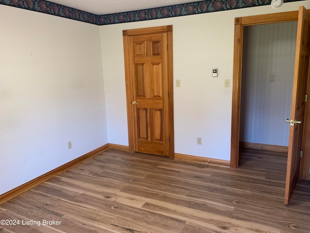 empty room with wood-type flooring