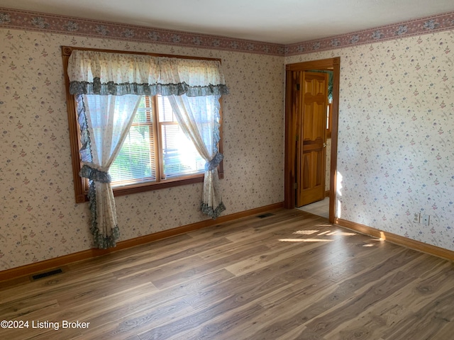 spare room with hardwood / wood-style floors