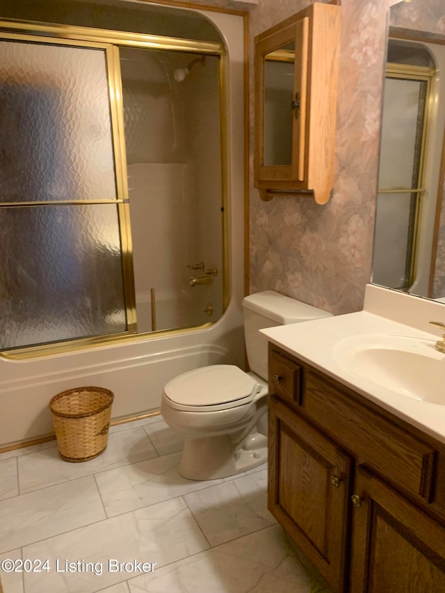 full bathroom featuring vanity, toilet, and combined bath / shower with glass door