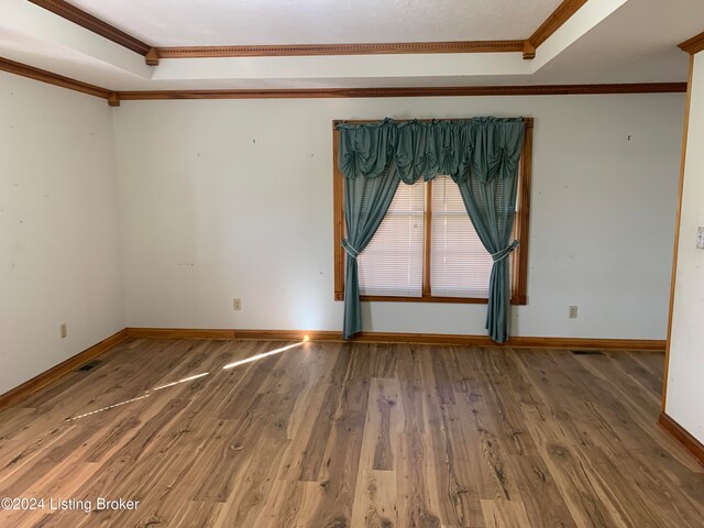 unfurnished room featuring crown molding and dark hardwood / wood-style flooring