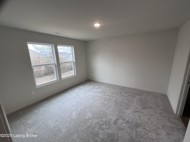 empty room with baseboards and carpet flooring