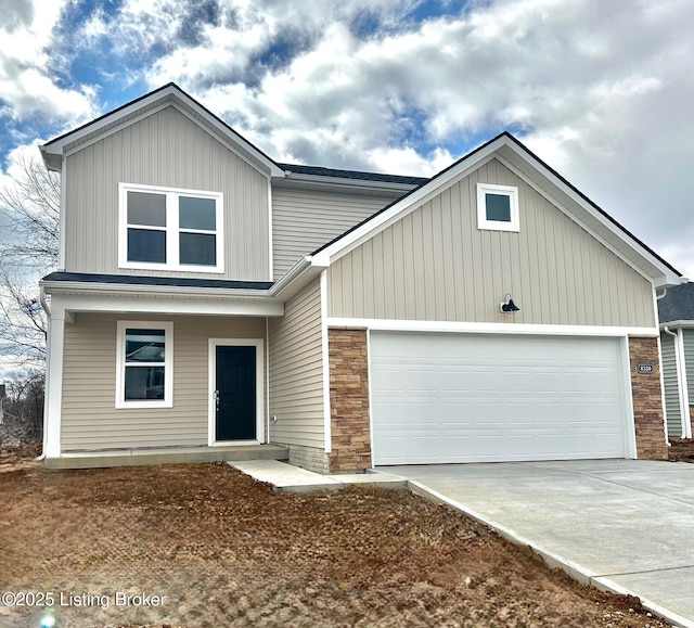 view of front facade with an attached garage, stone siding, and concrete driveway