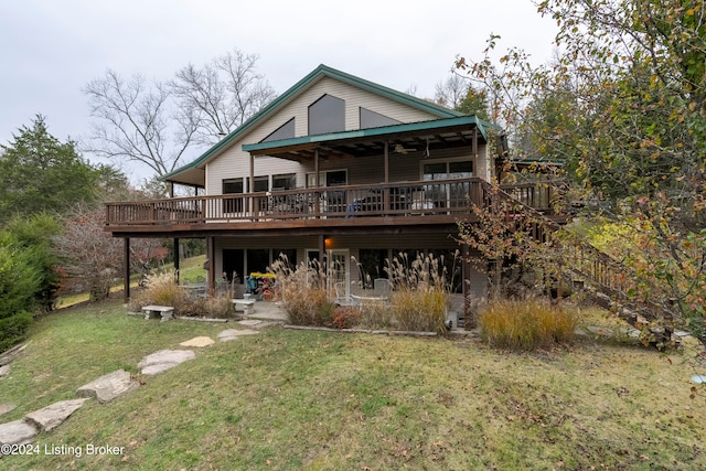 back of house featuring a deck, ceiling fan, and a lawn