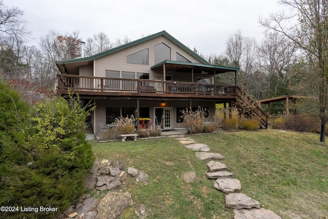 back of property featuring a lawn and a deck