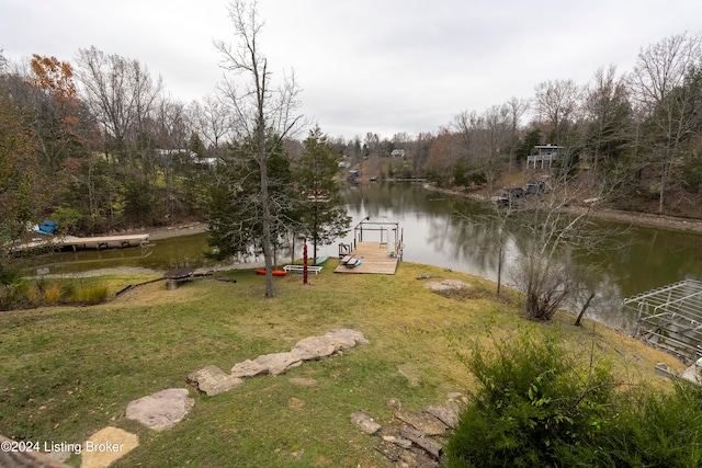 view of yard with a dock and a water view