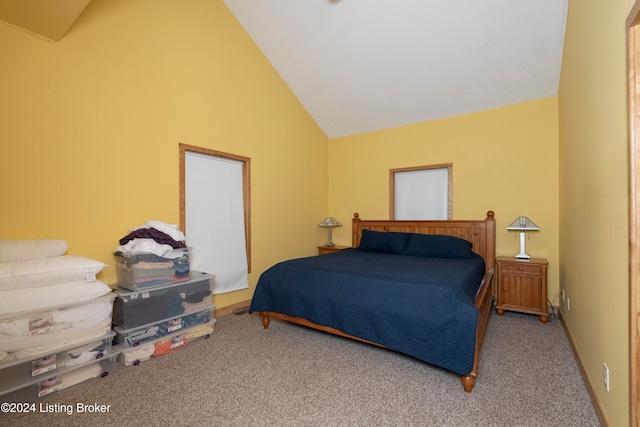 carpeted bedroom featuring high vaulted ceiling