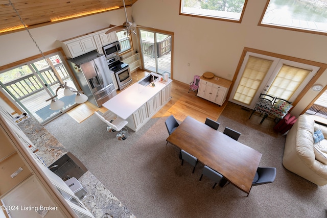 living room with ceiling fan, light hardwood / wood-style flooring, high vaulted ceiling, and wood ceiling