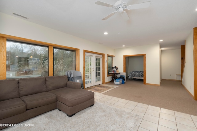 living room with light carpet, french doors, and ceiling fan