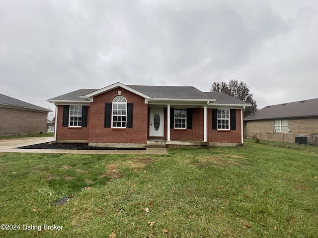 ranch-style house featuring central air condition unit, covered porch, and a front yard