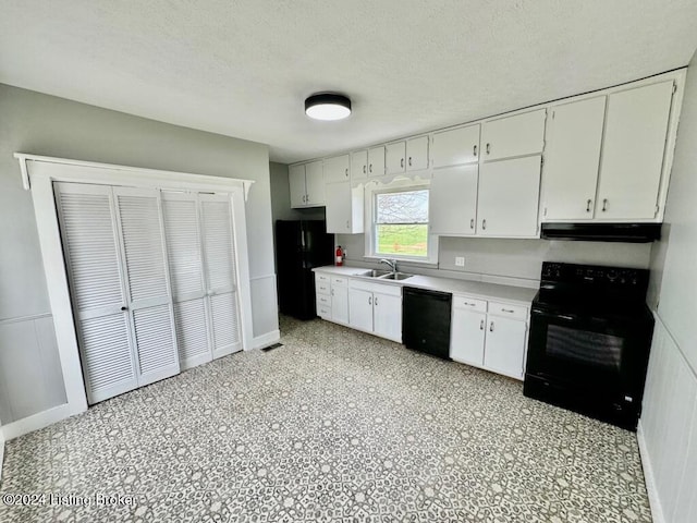 kitchen with sink, a textured ceiling, white cabinetry, and black appliances