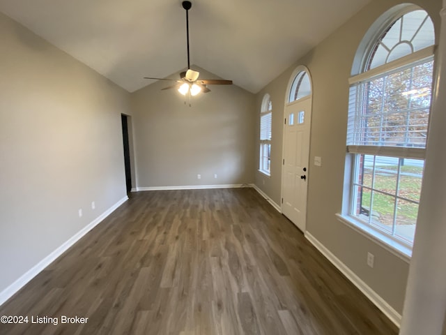 foyer entrance featuring ceiling fan, dark hardwood / wood-style flooring, a healthy amount of sunlight, and vaulted ceiling