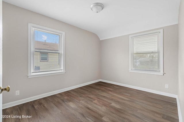 bonus room featuring dark hardwood / wood-style floors and vaulted ceiling