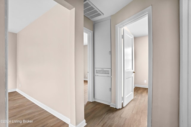 hallway with light hardwood / wood-style flooring