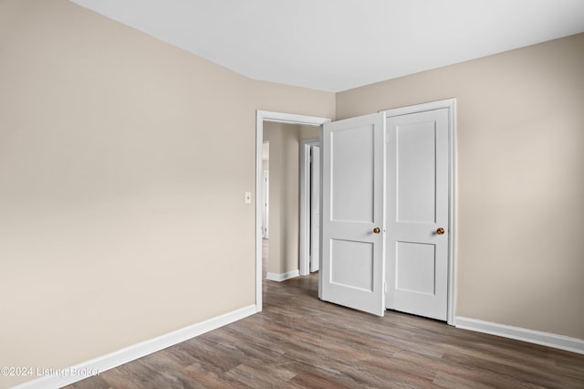 unfurnished bedroom featuring dark wood-type flooring