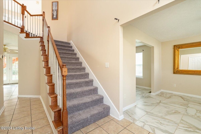 stairway with ceiling fan