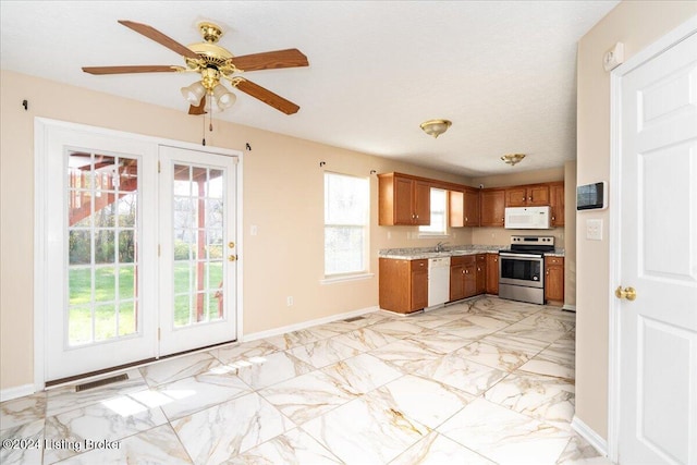 kitchen featuring ceiling fan, white appliances, and a textured ceiling