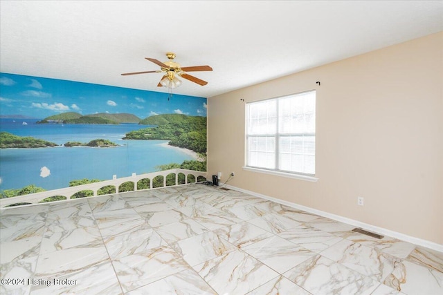 spare room with ceiling fan