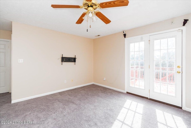 unfurnished room featuring ceiling fan and carpet floors