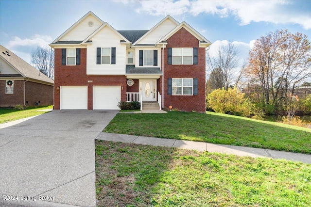 view of front of property with a front yard and a garage