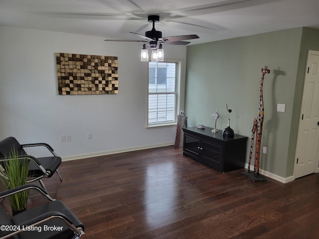 sitting room with dark hardwood / wood-style flooring and ceiling fan