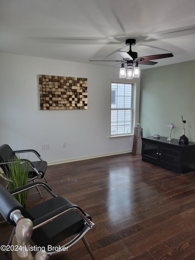 living area with ceiling fan and dark wood-type flooring