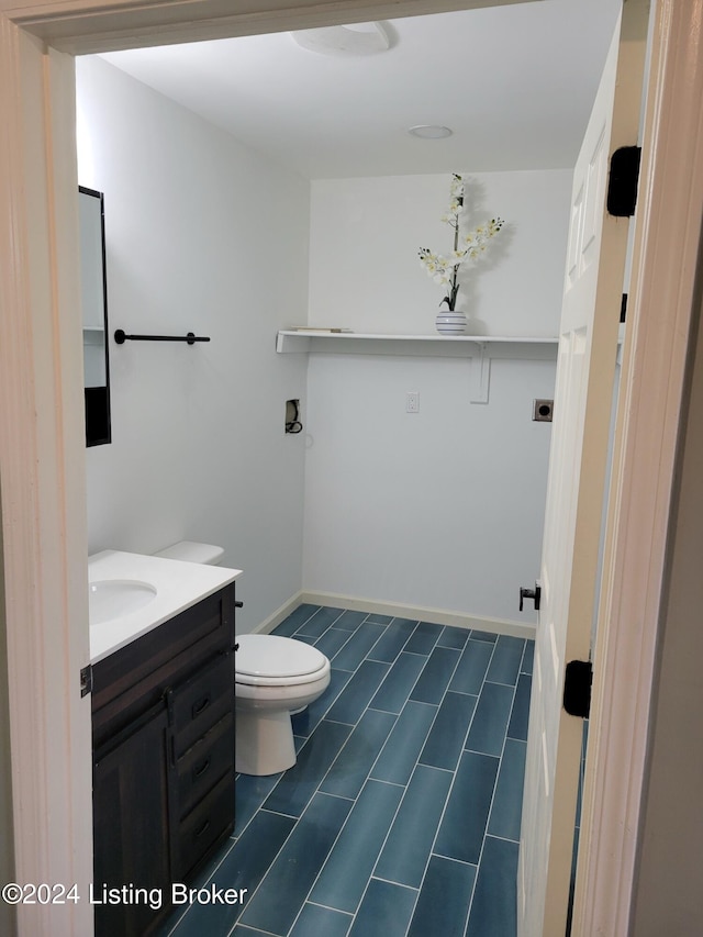 bathroom featuring tile patterned floors, vanity, and toilet