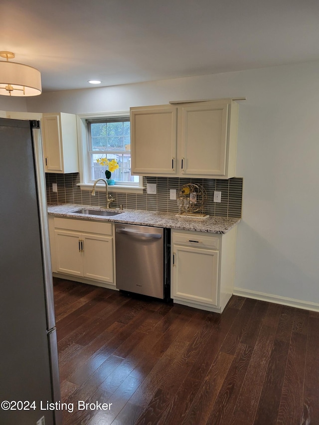 kitchen with decorative backsplash, dark hardwood / wood-style flooring, sink, and appliances with stainless steel finishes