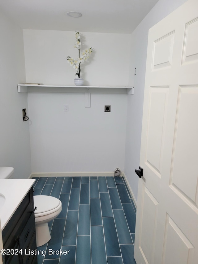 bathroom featuring tile patterned flooring, vanity, and toilet