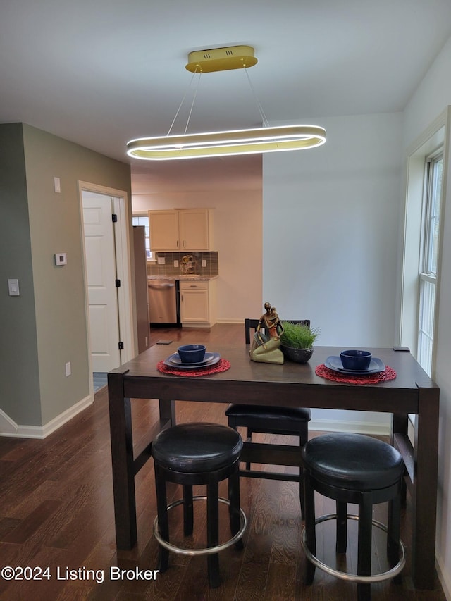 dining room with dark hardwood / wood-style flooring