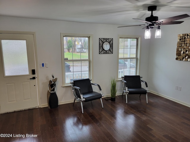 sitting room with dark hardwood / wood-style flooring and ceiling fan