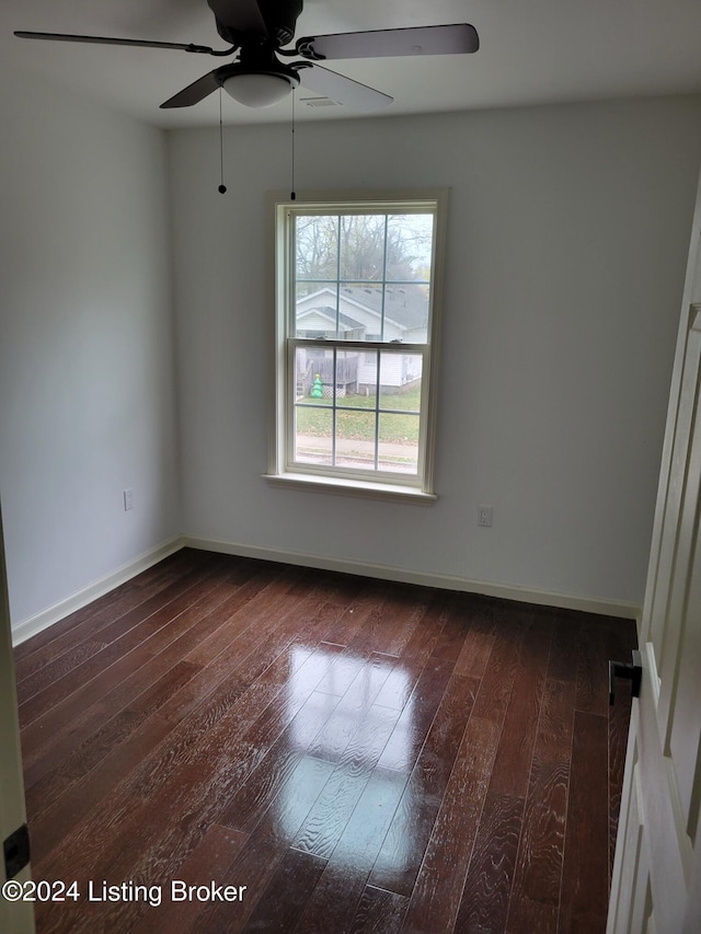 unfurnished room featuring ceiling fan and dark wood-type flooring