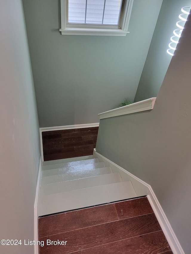 staircase featuring hardwood / wood-style flooring