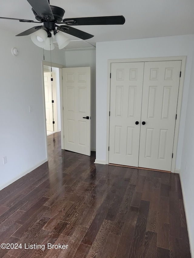 unfurnished bedroom with a closet, dark hardwood / wood-style floors, and ceiling fan