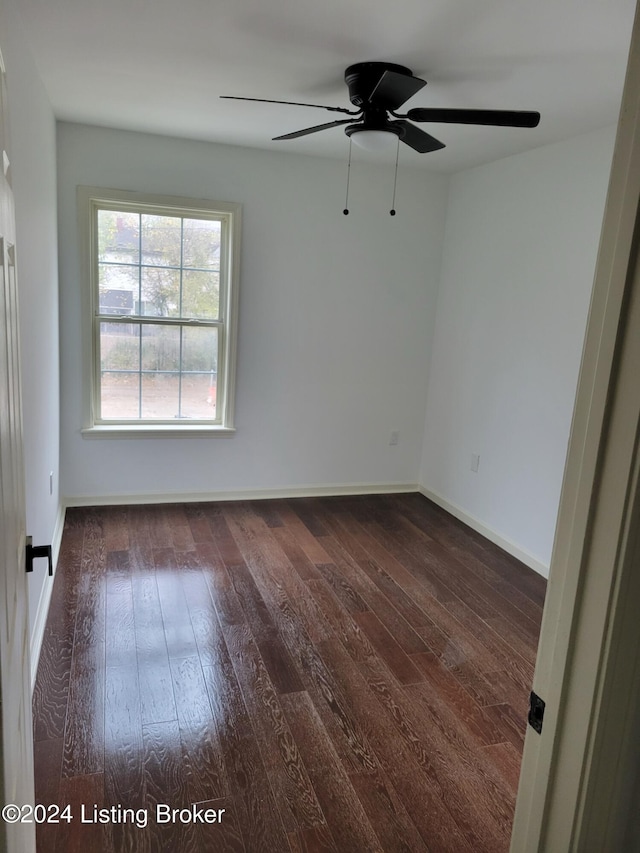 unfurnished room featuring dark hardwood / wood-style floors and ceiling fan