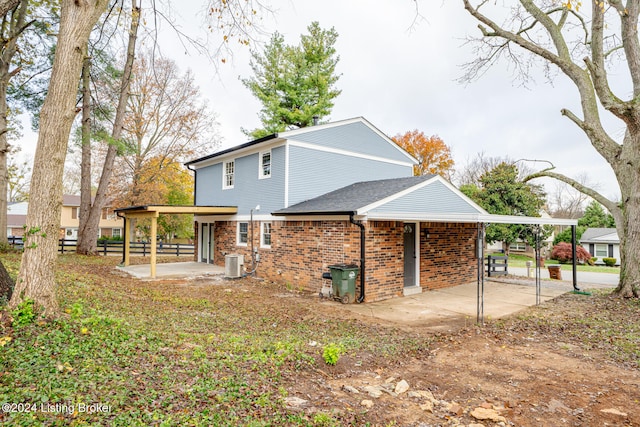 view of side of home featuring a patio area and central AC