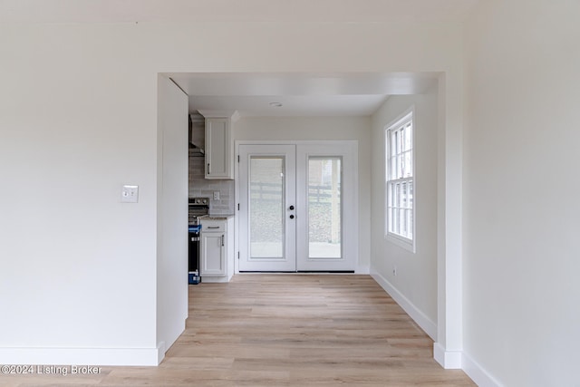 interior space with french doors and light wood-type flooring