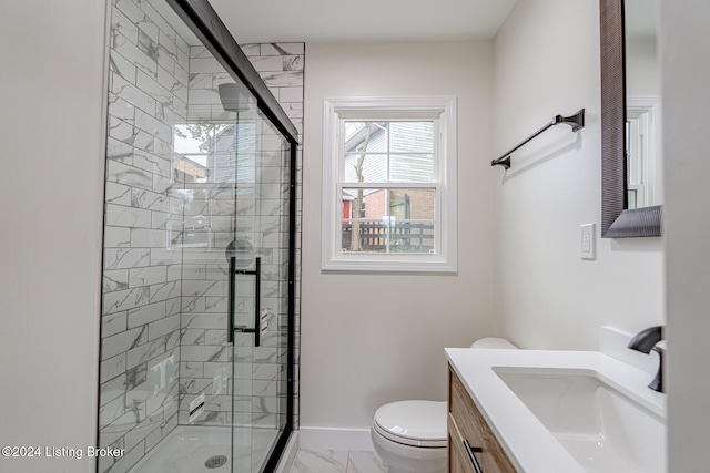 bathroom with vanity, toilet, and a shower with shower door