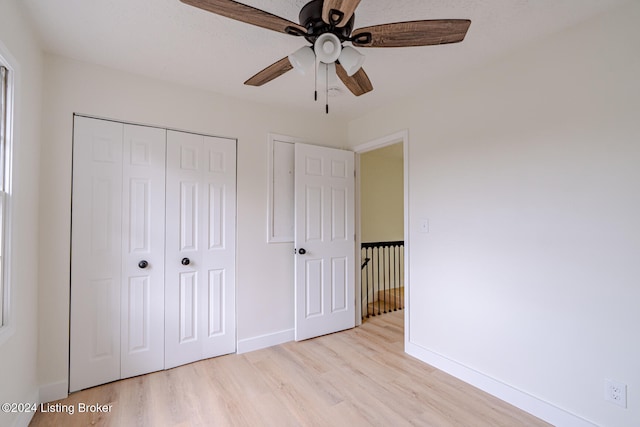 unfurnished bedroom with a closet, ceiling fan, and light hardwood / wood-style flooring